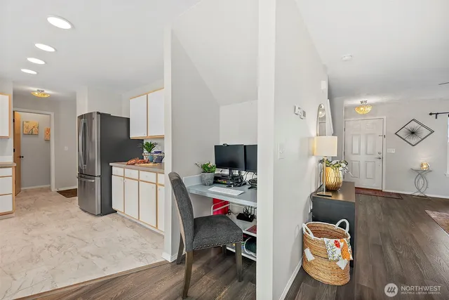 a view of a workspace with furniture and wooden floor