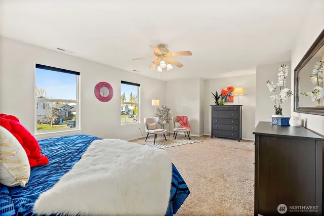 a bedroom with a bed and a dresser in it