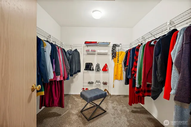 a view of walk in closet with clothes