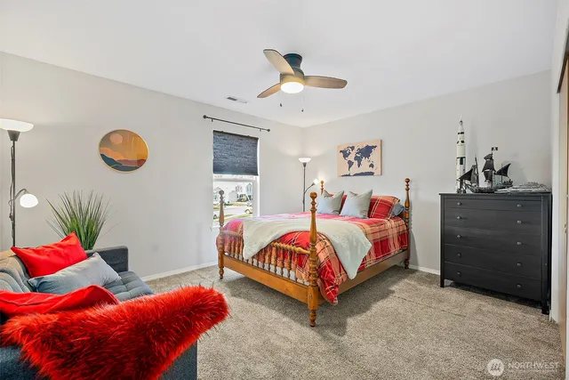 a bedroom with a bed and a chandelier