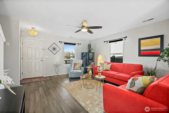 a living room with furniture and wooden floor