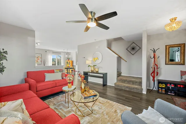 a living room with furniture and wooden floor