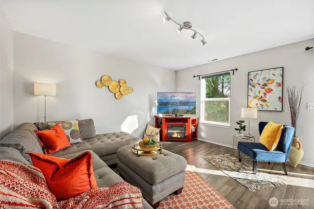 a living room with furniture fireplace and window