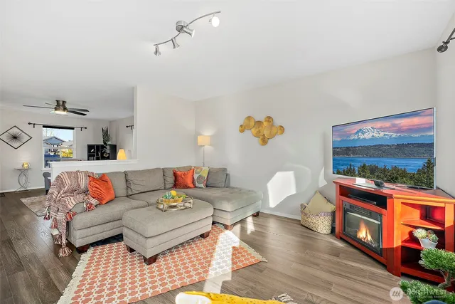 a living room with furniture and a floor to ceiling window