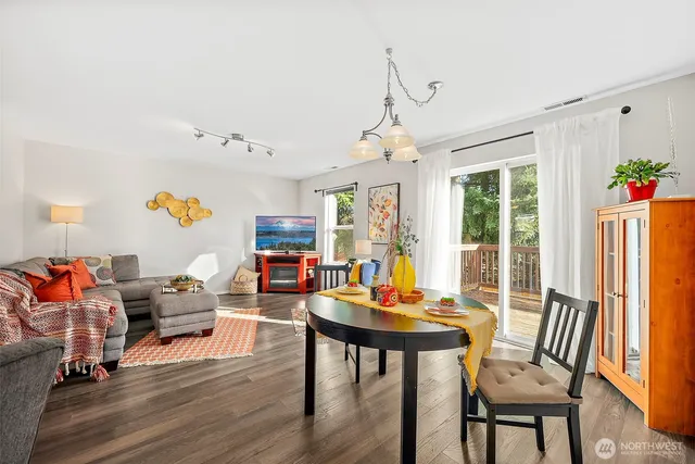a view of a dining room with furniture window and wooden floor