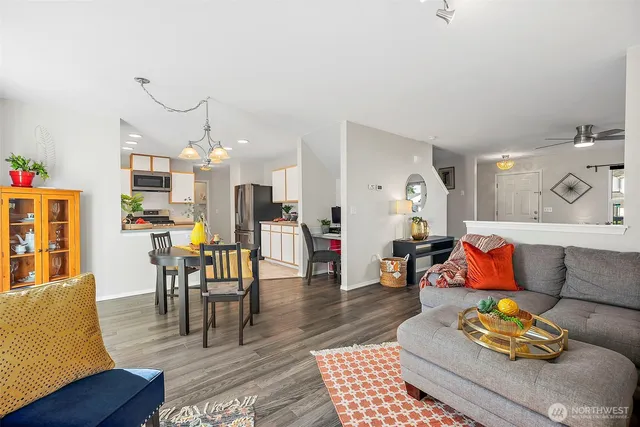 a living room with furniture kitchen view and a dining table