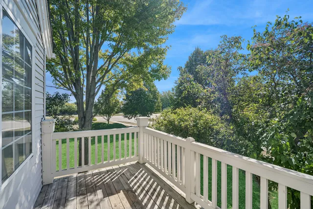 a view of a wooden deck and trees