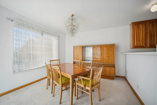 a view of a dining room with furniture and window
