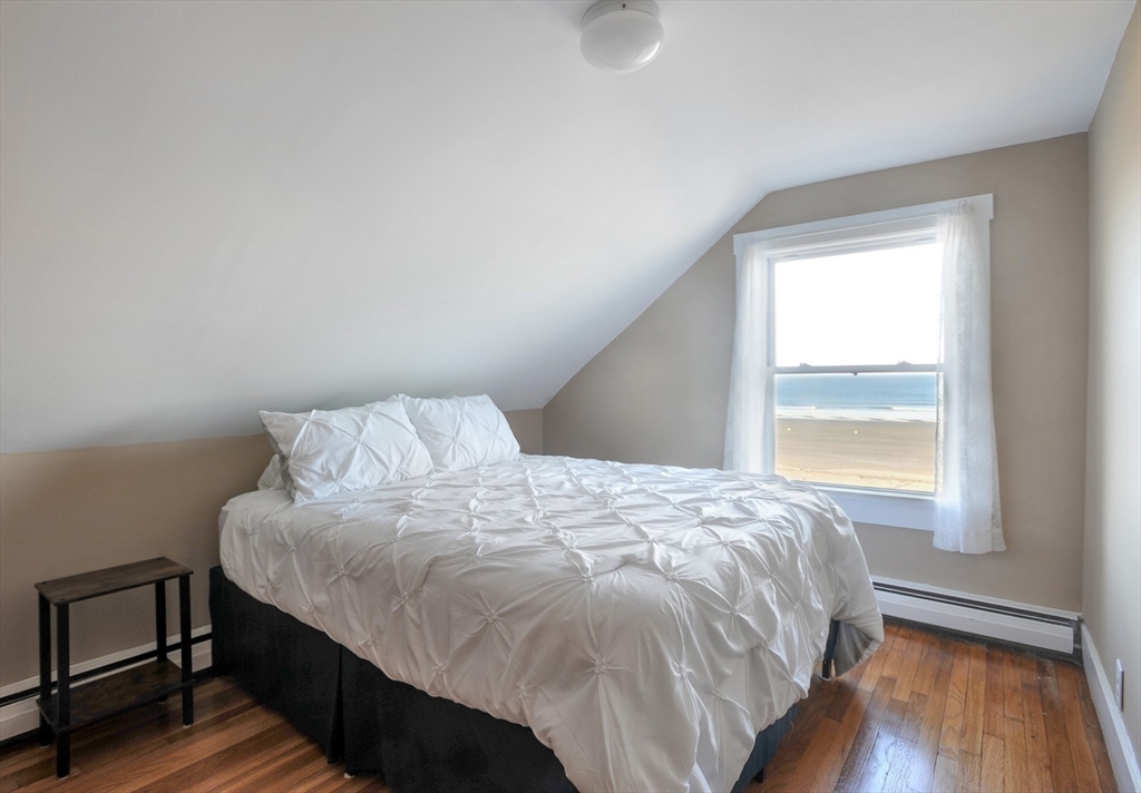 69 Beach Avenue Hull, MA 02045 - Photo 11 of 27 a bed sitting in a bedroom next to a window