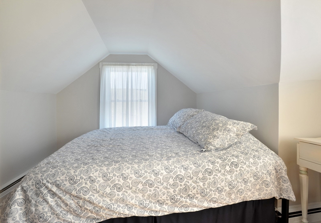 69 Beach Avenue Hull, MA 02045 - Photo 13 of 27 a bedroom with a bed and window