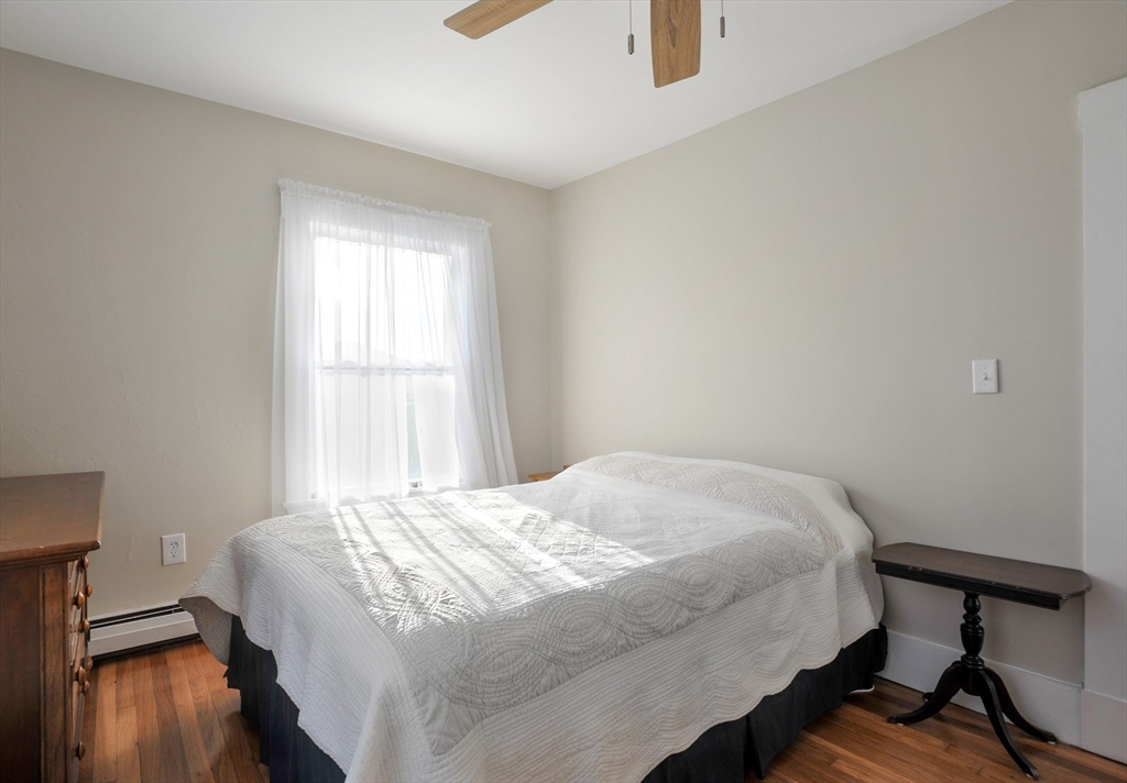 69 Beach Avenue Hull, MA 02045 - Photo 16 of 27 a bedroom with a bed and a window