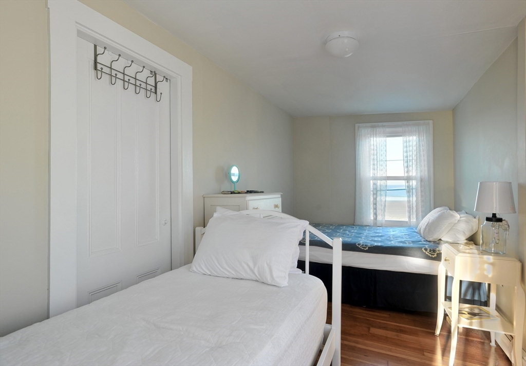 69 Beach Avenue Hull, MA 02045 - Photo 17 of 27 a bedroom with a bed and window