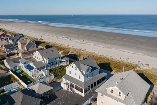 an aerial view of a house with a ocean view