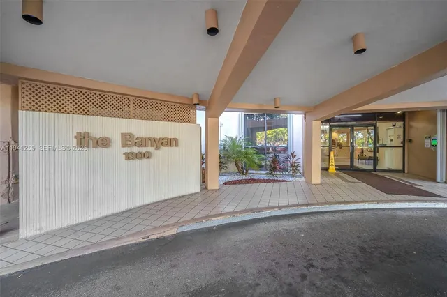 a view of a hallway with wooden floor and a dining space