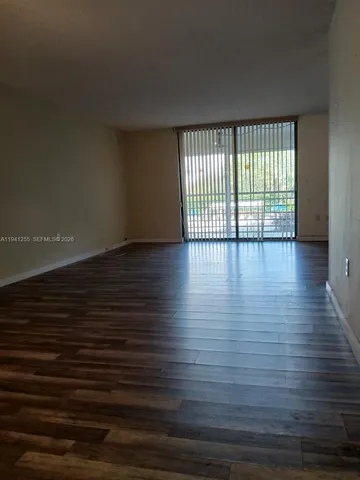 a view of wooden floor and windows in a room