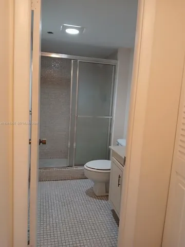 a bathroom with a toilet and a shower