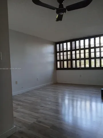 a view of wooden floor and windows in a room