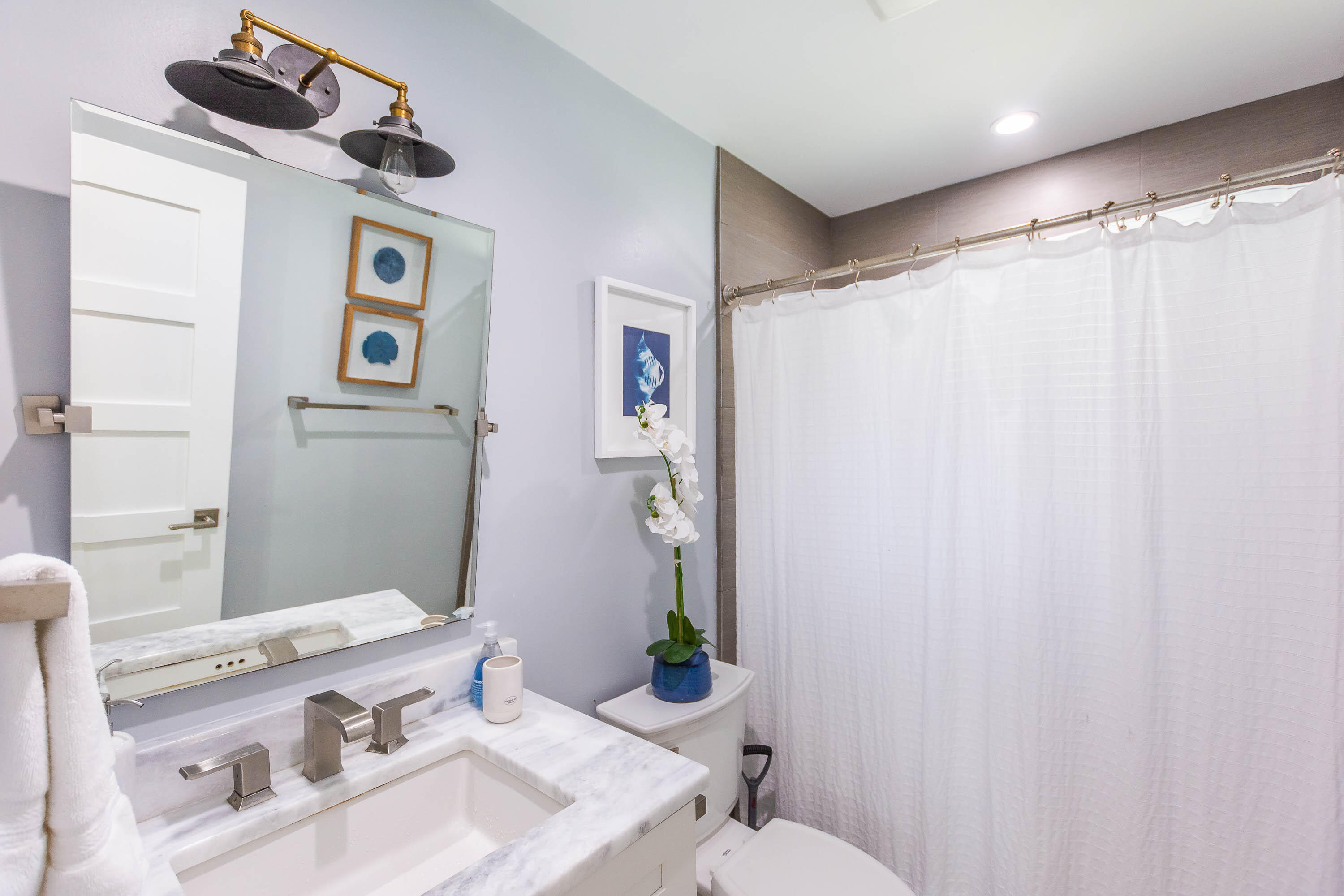 2830 Southwest 5th Street Boynton Beach, FL 33435 - Photo 13 of 26 a bathroom with a sink vanity mirror and toilet