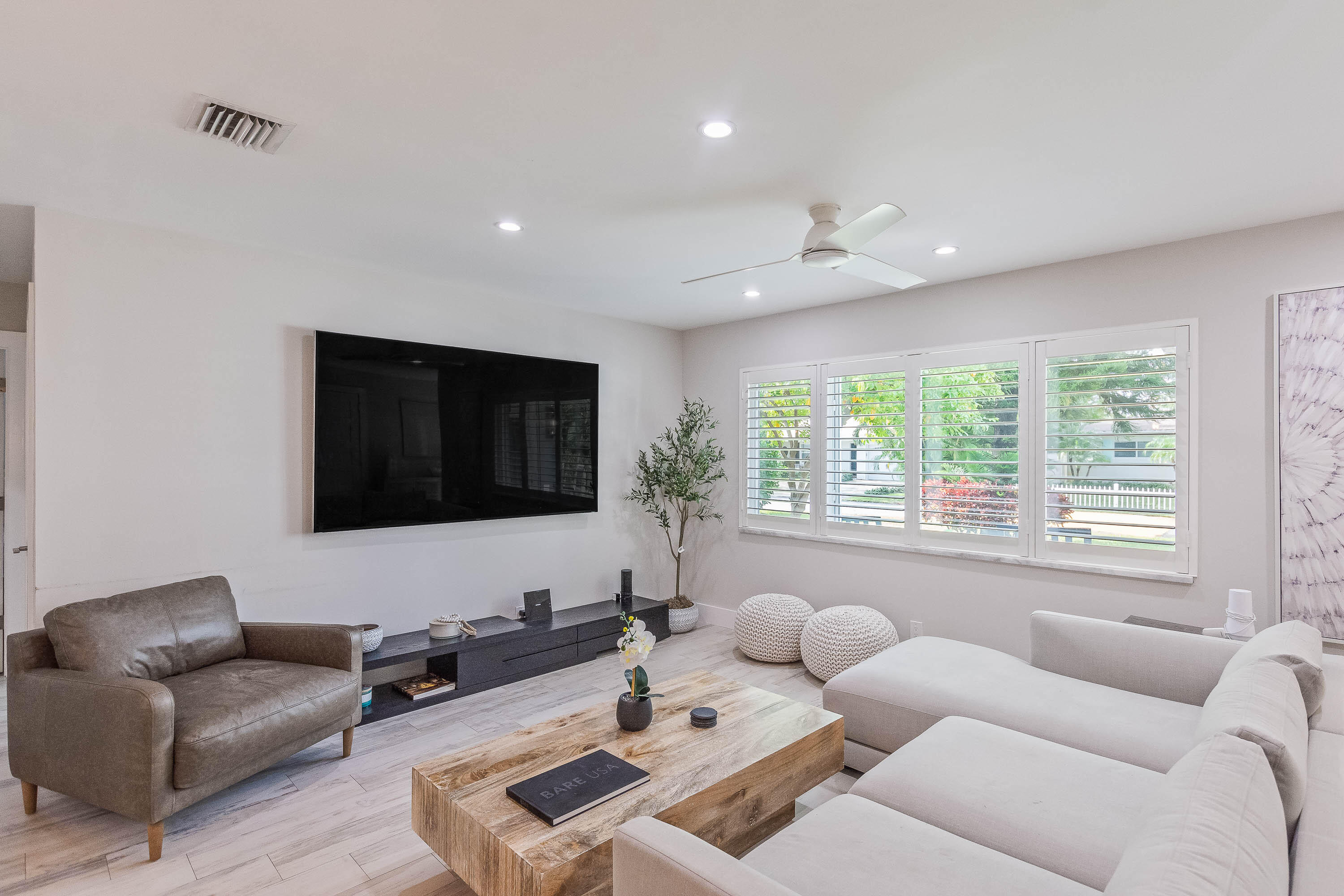 2830 Southwest 5th Street Boynton Beach, FL 33435 - Photo 2 of 26 a living room with furniture and a flat screen tv