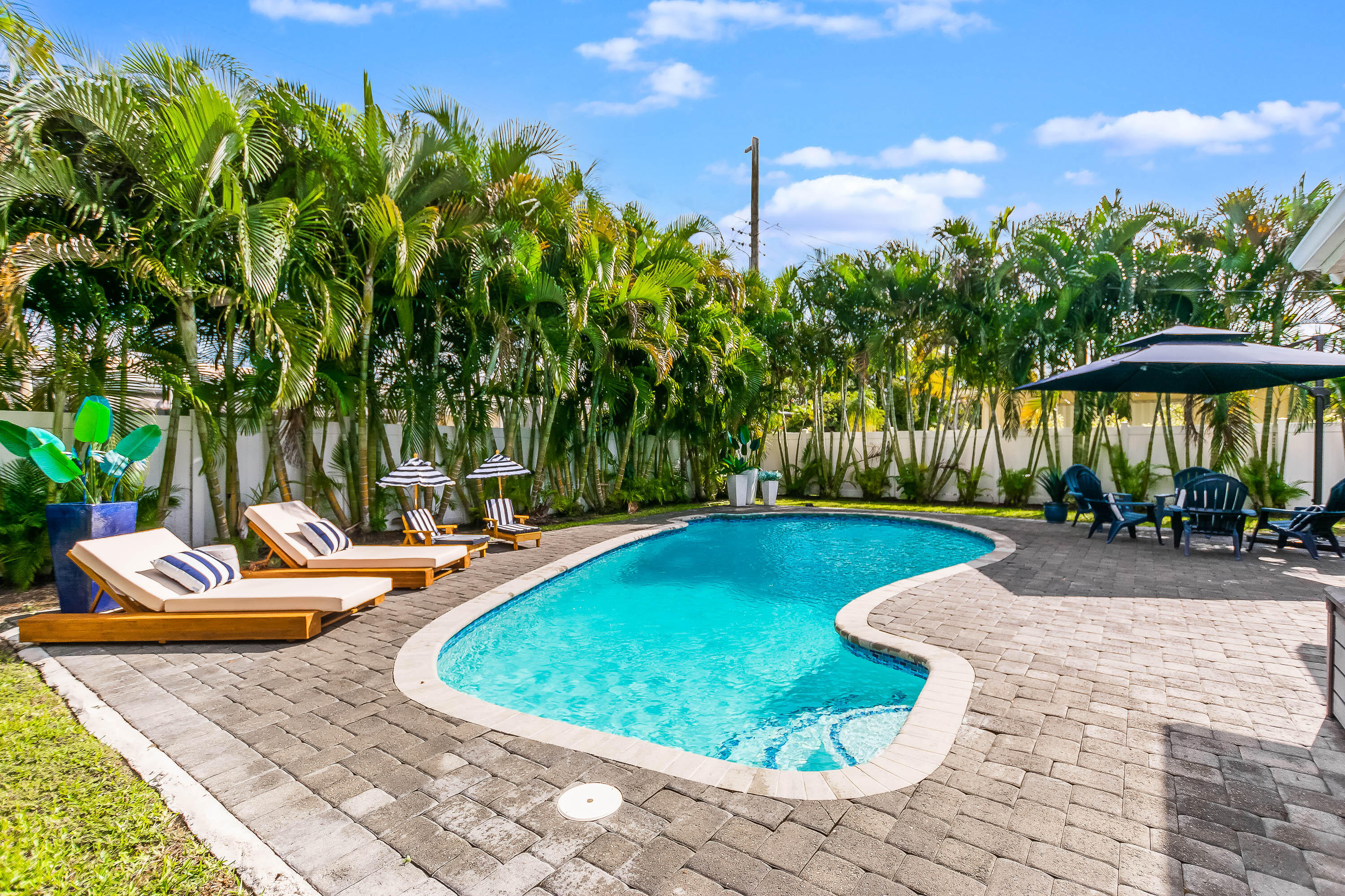 2830 Southwest 5th Street Boynton Beach, FL 33435 - Photo 24 of 26 a view of a swimming pool with a lounge chairs