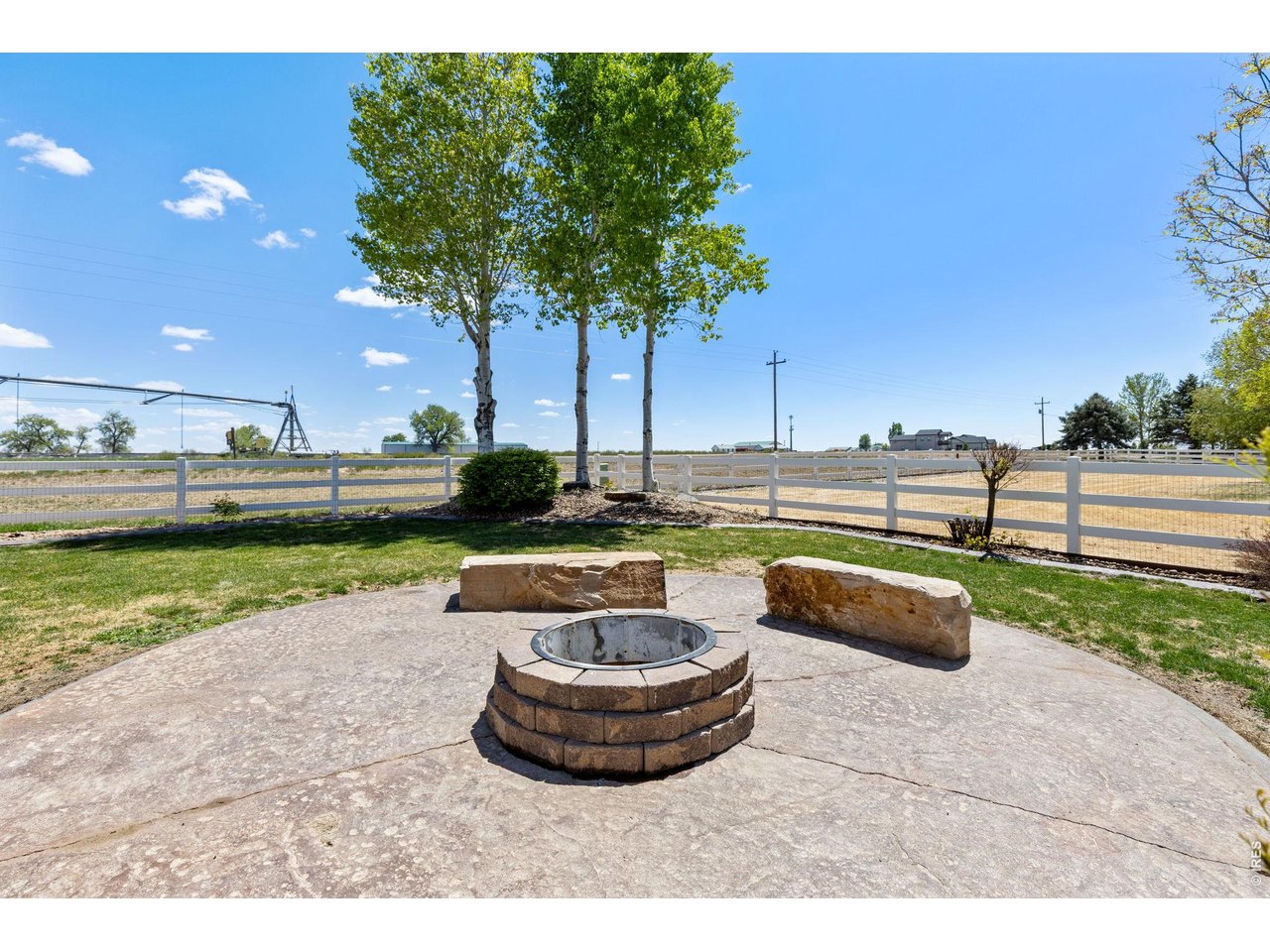 2002 Trail Ridge Drive Severance, CO 80615 - Photo 43 of 50 The backyard is built for enjoying Colorado living with mature trees, a spacious 550 sq ft stamped patio, and a dedicated firepit area perfect for entertaining on summer evenings. Mature landscaping & trees! Sprinkler system in place.