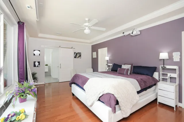 a bed room with a bed and a chandelier