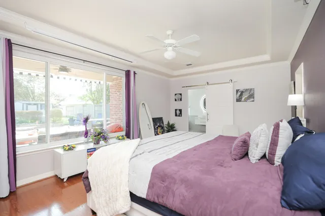 a bedroom with a large bed and a large window