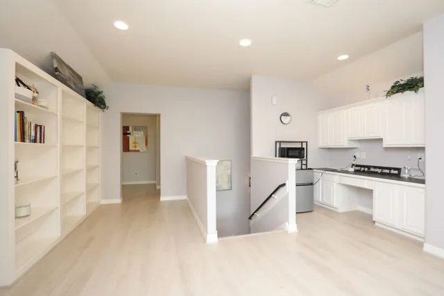 a kitchen with white cabinets and appliances