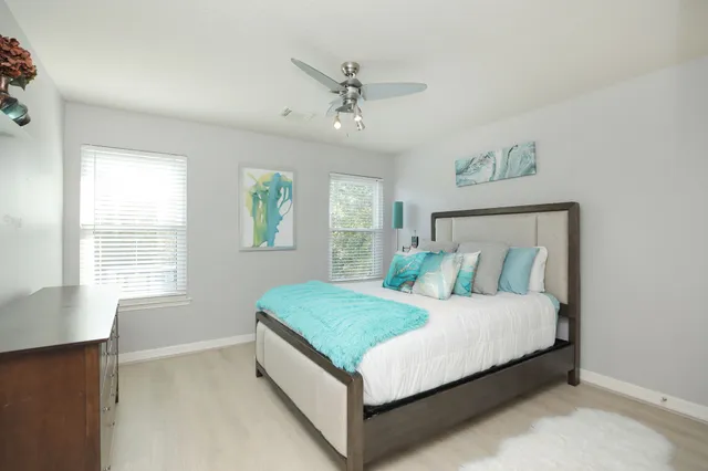 a bed sitting in a bedroom next to a window