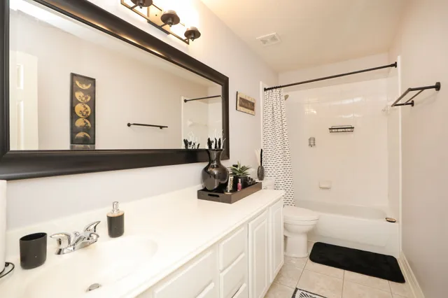 a bathroom with a double vanity sink a mirror and shower
