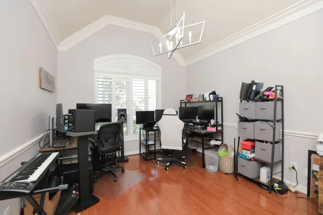 a view of a workspace with furniture and a window