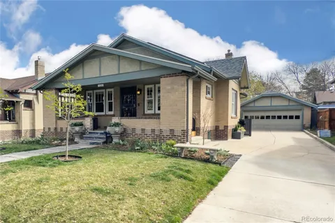 a view of house with swimming pool and a yard