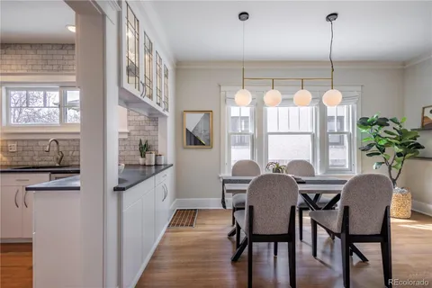 a kitchen with stainless steel appliances granite countertop a stove and a wooden floors