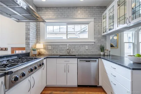 a kitchen with granite countertop a sink and cabinets