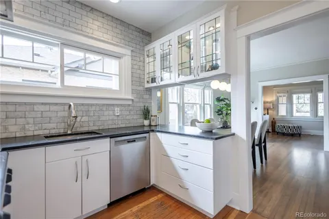 a kitchen with kitchen island a counter top space a sink and stainless steel appliances