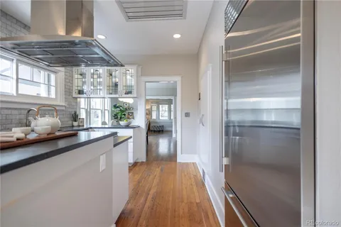 a kitchen with stainless steel appliances granite countertop a stove and a refrigerator