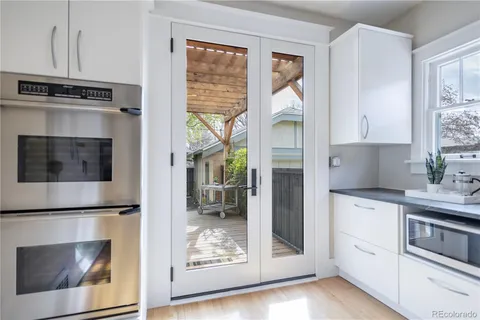 a kitchen with stainless steel appliances granite countertop a refrigerator and microwave