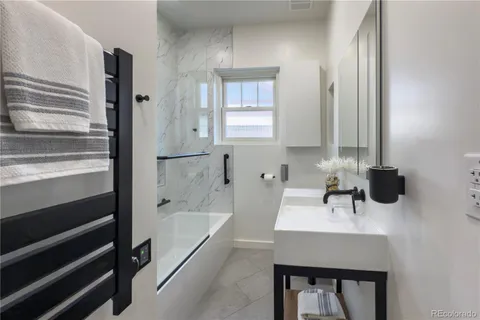 a bedroom with a bed lamps and window