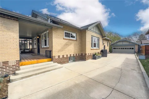 a view of a patio with wooden floor and iron stairs