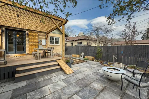 a view of a backyard with sitting area