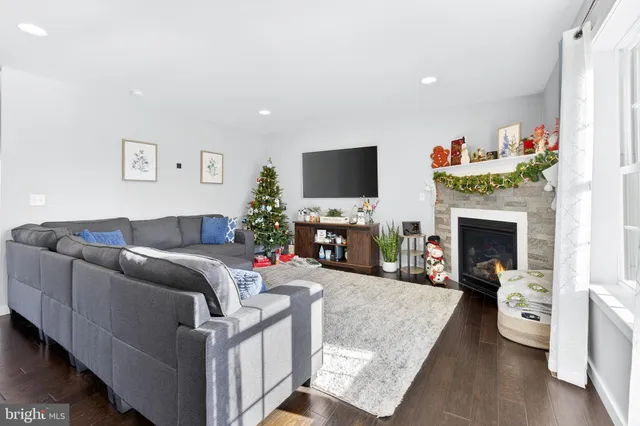 a living room with furniture a fireplace and a flat screen tv