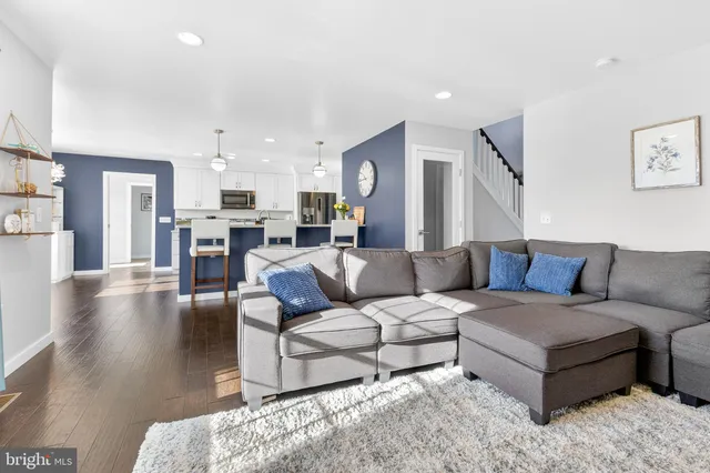a living room with furniture and kitchen view