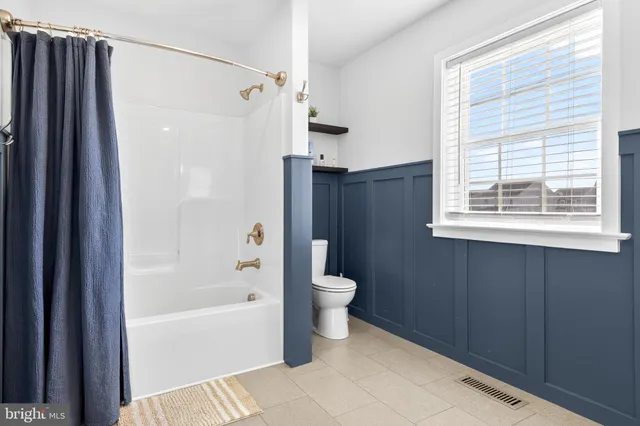 a bathroom with a bathtub toilet and a shower