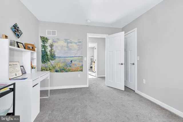 a view of kitchen with furniture and refrigerator