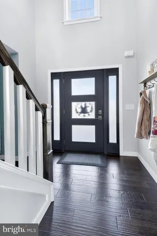 a view of hallway with stairs and wooden floor