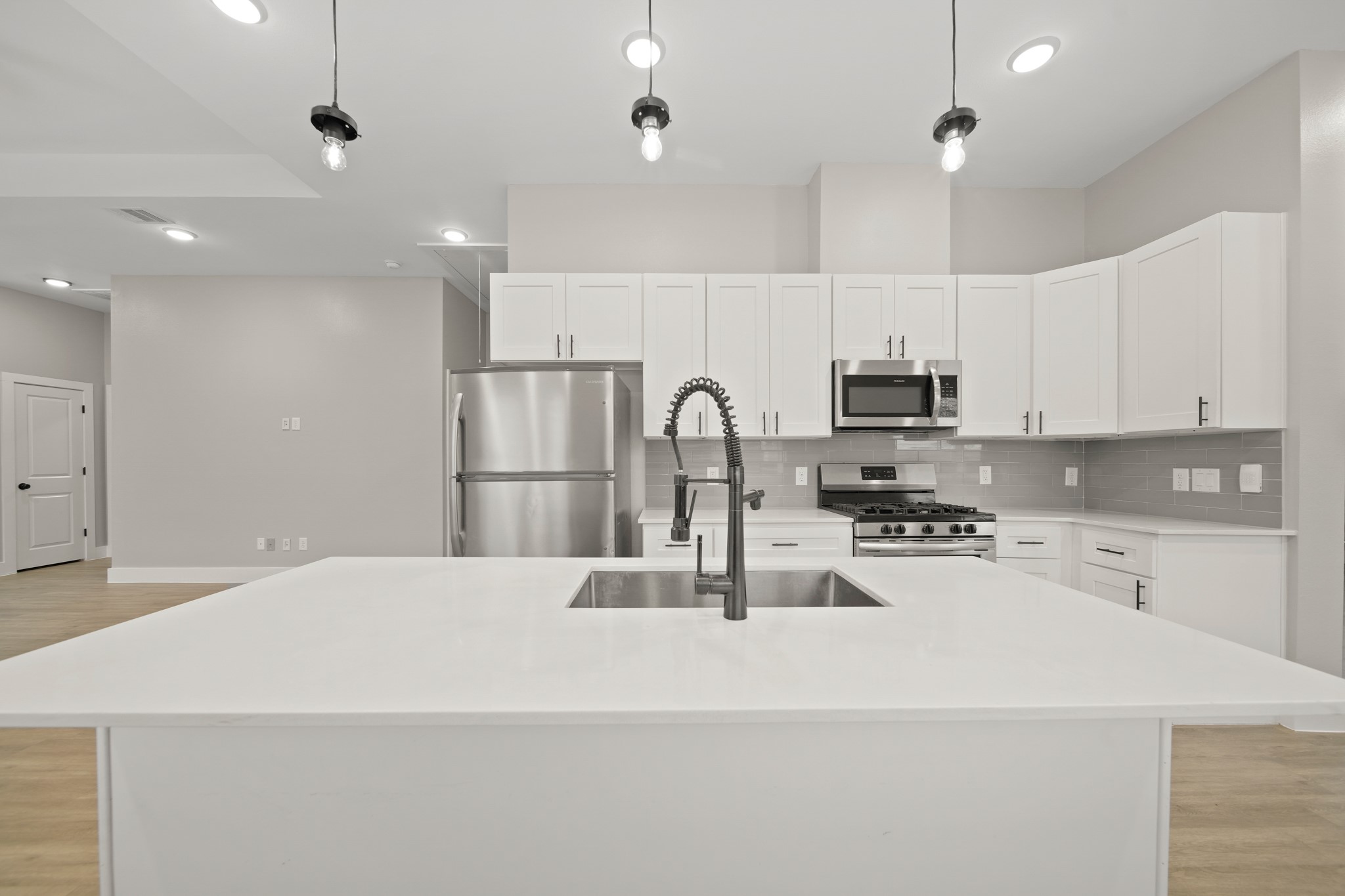 507 Carl Street Houston, TX 77009 - Photo 11 of 25 a kitchen with kitchen island a sink stainless steel appliances and cabinets