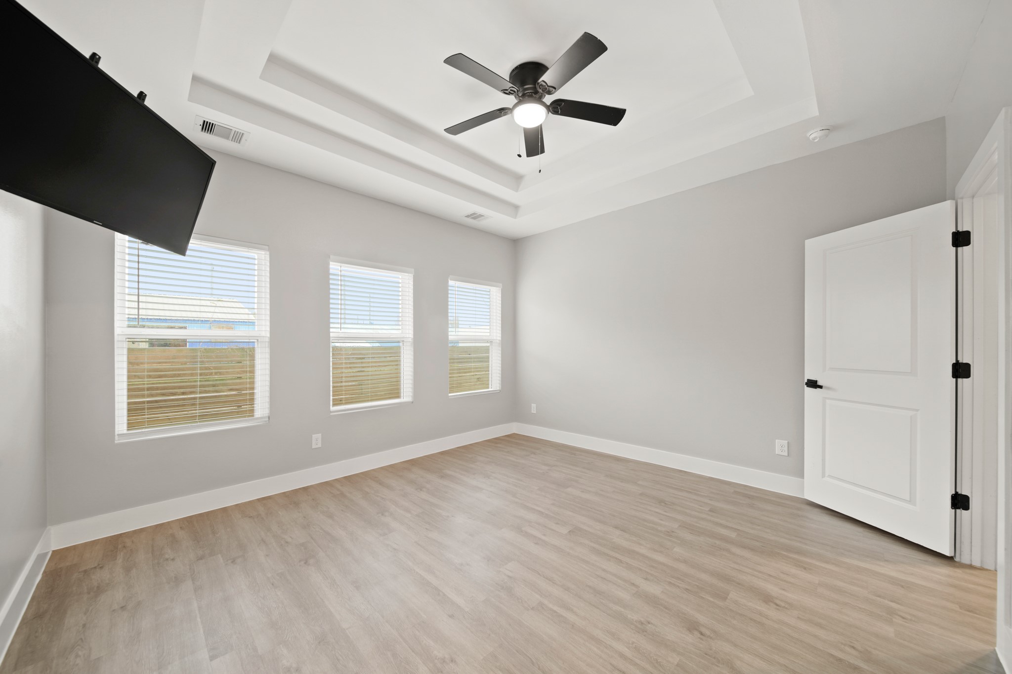 507 Carl Street Houston, TX 77009 - Photo 15 of 25 a view of an empty room with a window and wooden floor