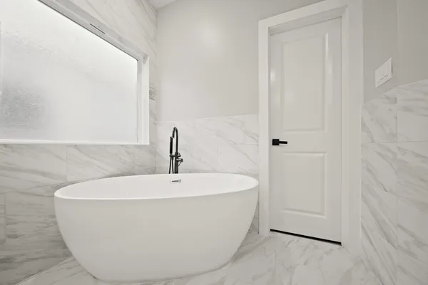 a white bath tub sitting in a bathroom