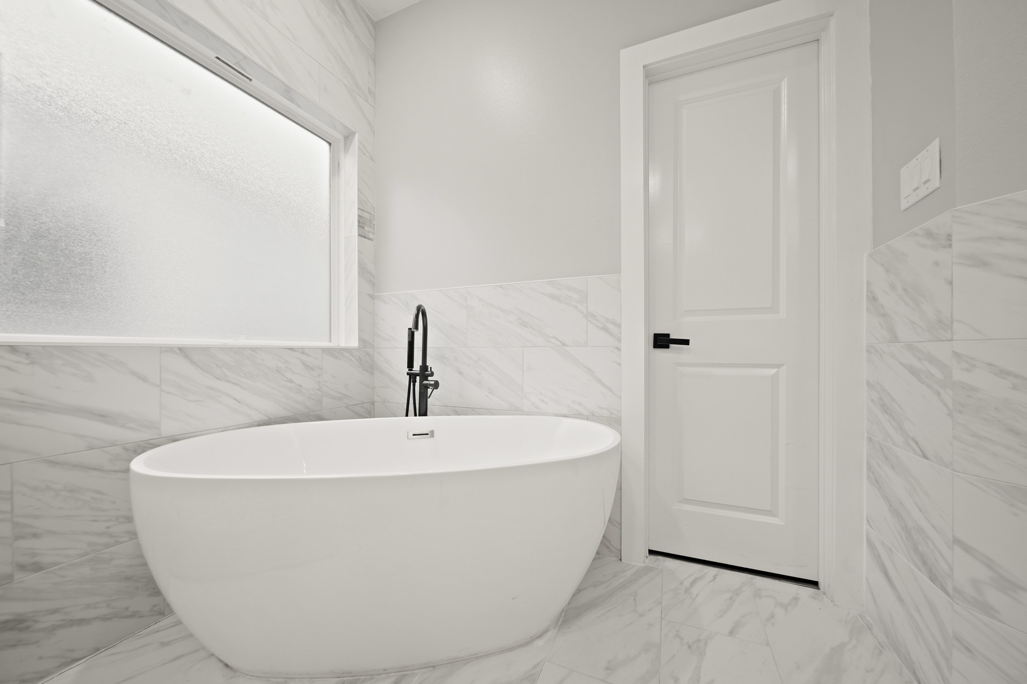 507 Carl Street Houston, TX 77009 - Photo 20 of 25 a white bath tub sitting in a bathroom