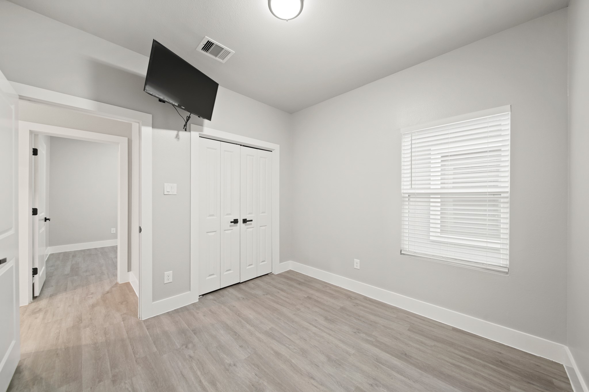 507 Carl Street Houston, TX 77009 - Photo 24 of 25 a view of an empty room with wooden floor and a window
